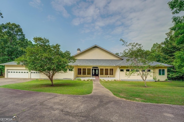 view of front of house featuring a front lawn, a porch, and a garage