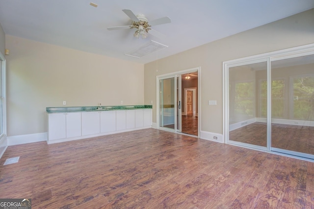 spare room featuring wood-type flooring and ceiling fan