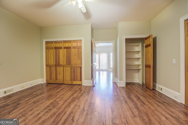 unfurnished bedroom with ceiling fan and dark hardwood / wood-style floors