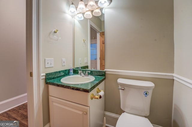 bathroom with vanity, hardwood / wood-style flooring, and toilet