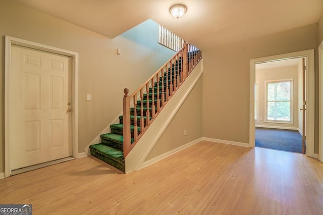 stairs with hardwood / wood-style floors