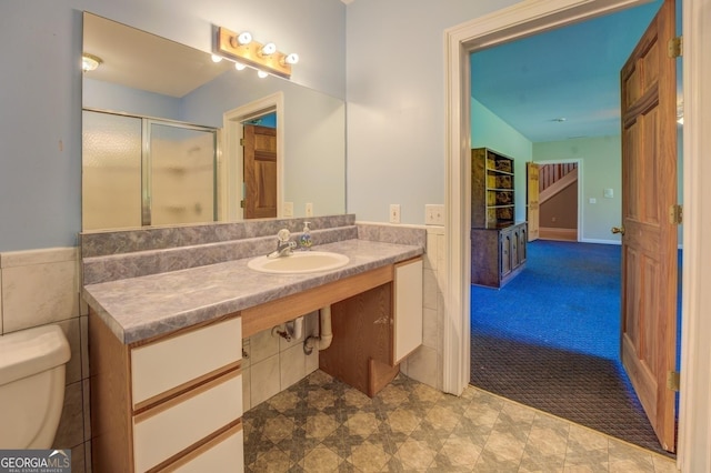 bathroom featuring sink, an enclosed shower, and toilet