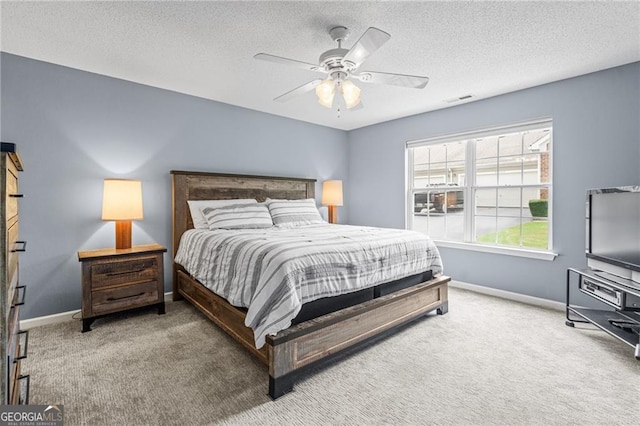 bedroom with carpet flooring, a textured ceiling, and ceiling fan