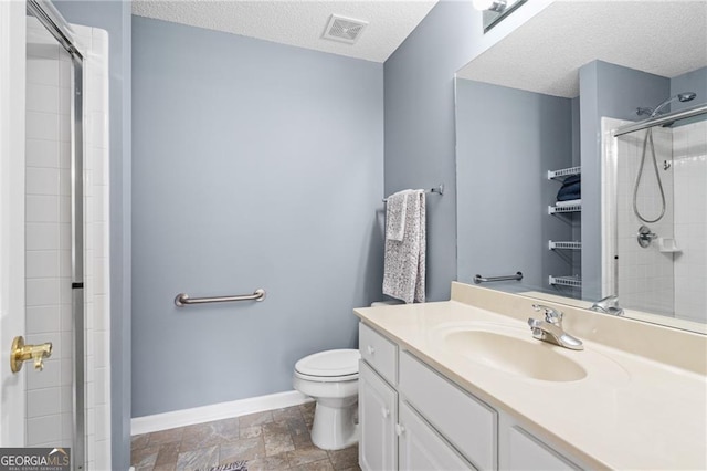 bathroom with walk in shower, vanity, a textured ceiling, and toilet