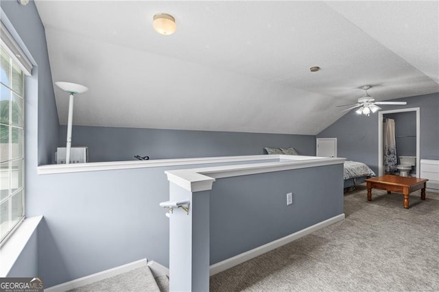 carpeted bedroom with vaulted ceiling and ceiling fan