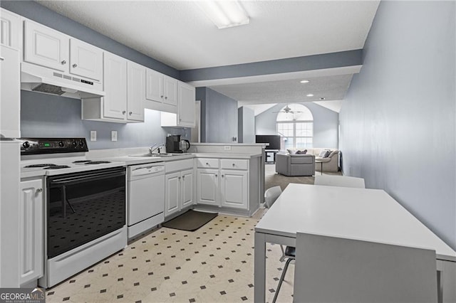 kitchen with kitchen peninsula, white appliances, ceiling fan, sink, and white cabinets