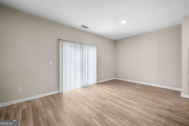 spare room featuring light hardwood / wood-style flooring