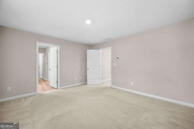 unfurnished bedroom with light carpet