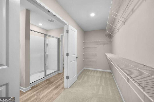 walk in closet with light wood-type flooring