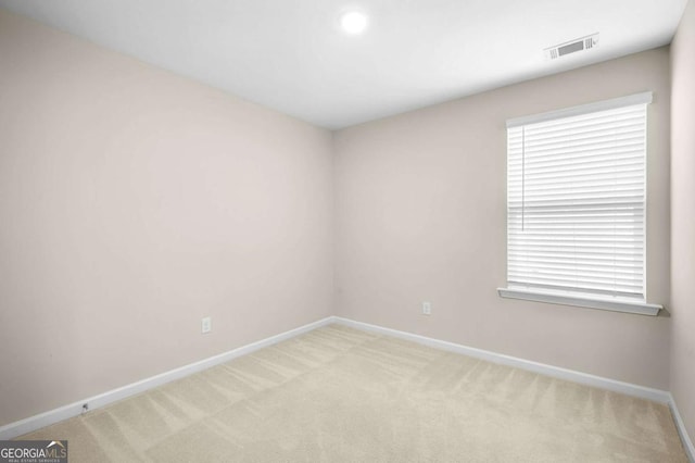 spare room with light carpet