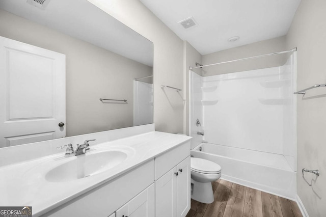 full bathroom with vanity, toilet, wood-type flooring, and shower / tub combination