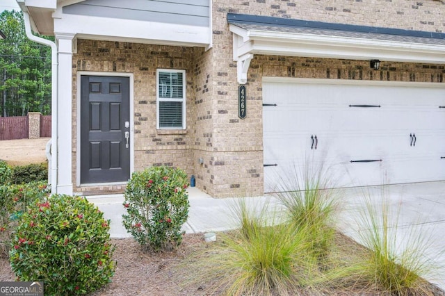 doorway to property with a garage