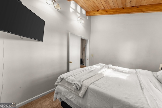 bedroom with beamed ceiling, wooden ceiling, and carpet floors