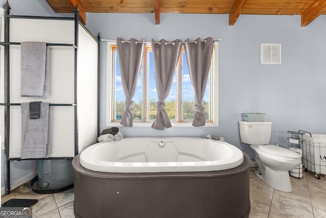 bathroom with tile patterned flooring, a washtub, toilet, beamed ceiling, and wood ceiling