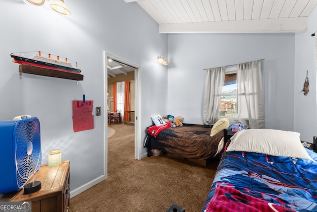 bedroom with lofted ceiling with beams and carpet floors