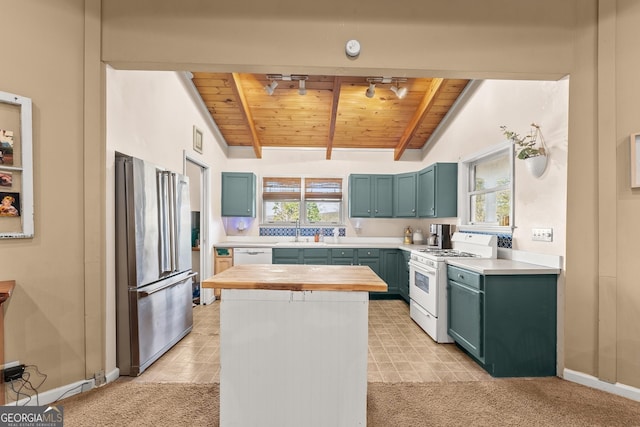 kitchen featuring wooden ceiling, lofted ceiling with beams, white range, high quality fridge, and plenty of natural light