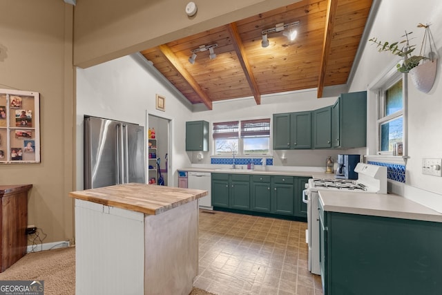 kitchen featuring high end fridge, wood ceiling, gas range, sink, and dishwasher