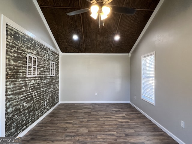 spare room with lofted ceiling, dark hardwood / wood-style floors, ceiling fan, and wooden ceiling