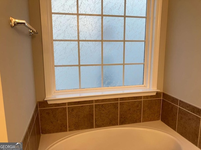 681 Courageous Ct, Lawrenceville, GA 30043 - full bath with a garden tub and plenty of natural light