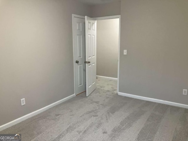 spare room with light colored carpet