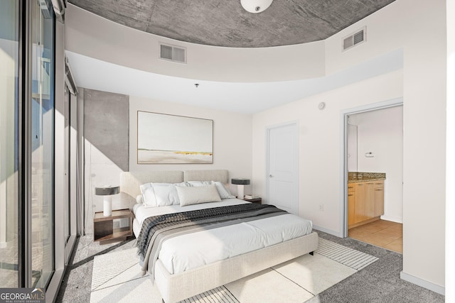 carpeted bedroom featuring connected bathroom