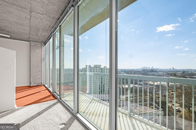 exterior space with carpet floors and expansive windows