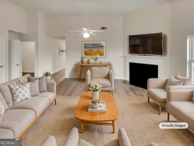 living room with hardwood / wood-style floors and ceiling fan