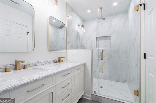 bathroom featuring vanity and an enclosed shower