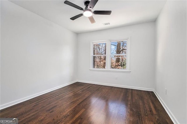 spare room with ceiling fan and dark wood-type flooring