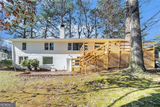 back of property featuring a yard and a deck