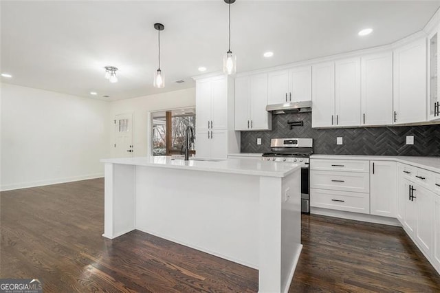 kitchen with stainless steel range, white cabinets, and sink