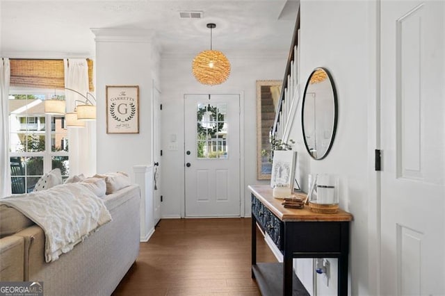 entryway with crown molding, dark hardwood / wood-style flooring, and a healthy amount of sunlight