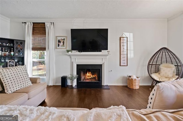 living room with a textured ceiling, dark hardwood / wood-style floors, and ornamental molding