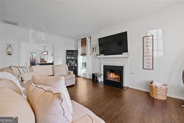 living room featuring ornamental molding, dark hardwood / wood-style floors, and a healthy amount of sunlight