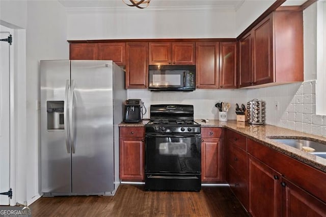 kitchen featuring black appliances, dark hardwood / wood-style floors, ornamental molding, tasteful backsplash, and light stone counters