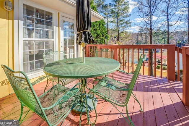 deck with outdoor dining area