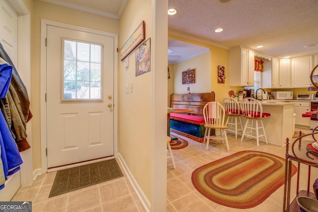 doorway with crown molding, light tile patterned floors, recessed lighting, a textured ceiling, and baseboards