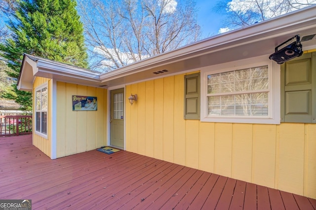 wooden deck featuring visible vents