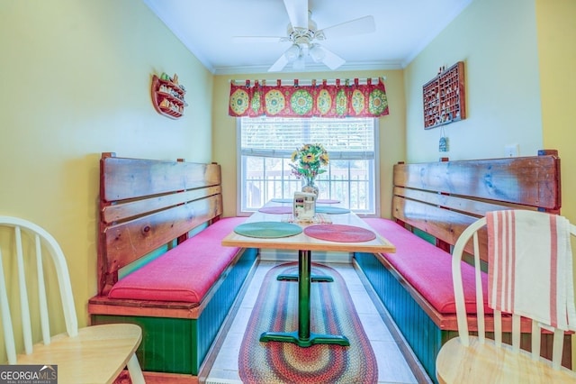 recreation room featuring a ceiling fan and crown molding