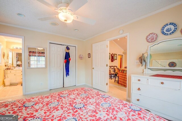 bedroom with ceiling fan, a closet, a textured ceiling, and ornamental molding