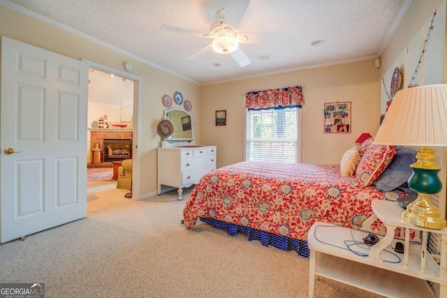 carpeted bedroom featuring ceiling fan, a fireplace, crown molding, and a textured ceiling