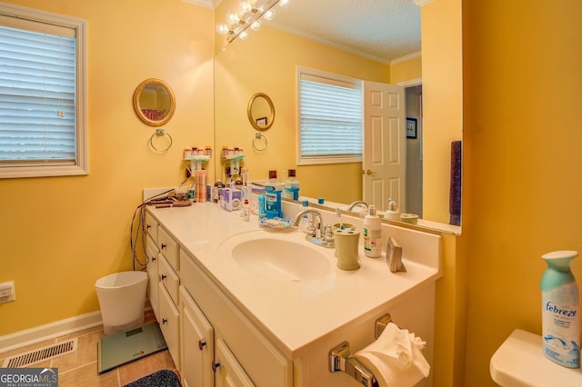 bathroom featuring baseboards, visible vents, toilet, a textured ceiling, and vanity