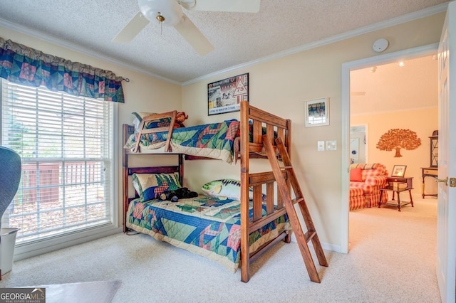 bedroom with carpet floors, a textured ceiling, crown molding, and ceiling fan