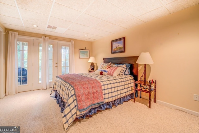 carpeted bedroom with baseboards, access to outside, a paneled ceiling, and recessed lighting