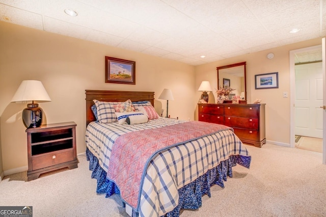 carpeted bedroom featuring baseboards and recessed lighting