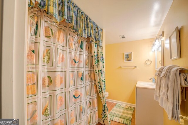 bathroom with tile patterned floors, vanity, and toilet