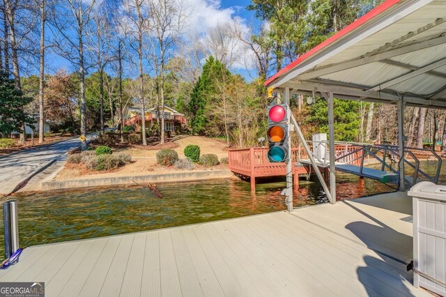 exterior space featuring a boat dock and a water view