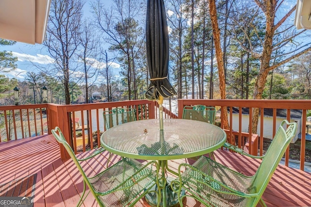 wooden deck featuring outdoor dining area