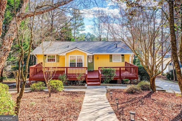 view of front of home featuring roof with shingles and a porch