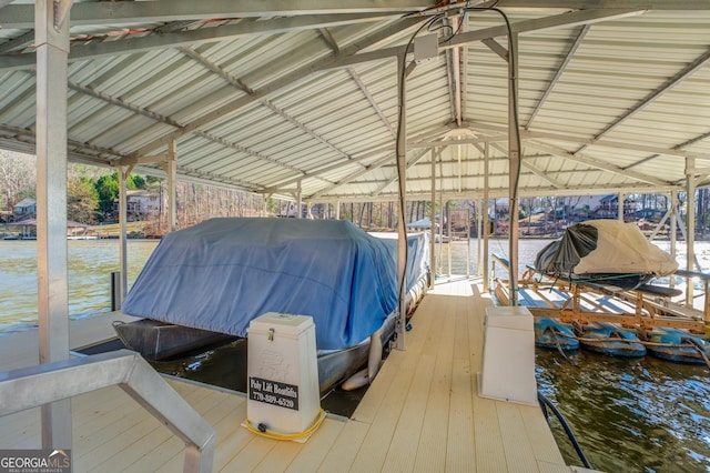 view of dock with boat lift and a water view